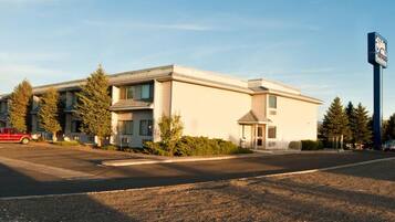 A two-story motel with a central entrance and a small porch.