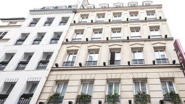 A multi-story hotel with a classic architectural style, featuring a central entrance with a sign, balconies with plants, and a visible 'H' logo on the facade. - Hôtel Haussmann Saint Augustin (Paris)