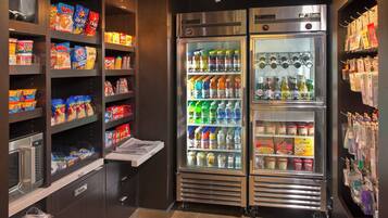 A vending area with snack and drink options, a microwave, and a trash bin.