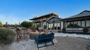 A modern building with a fire pit and outdoor seating area. - Tombstone Lookout Lodge, SureStay Collection by Best Western (Tombstone)