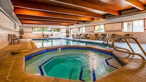 An indoor swimming pool with clear water, wooden ceiling beams, and tiled walls. - Best Western John Day Inn (John Day)