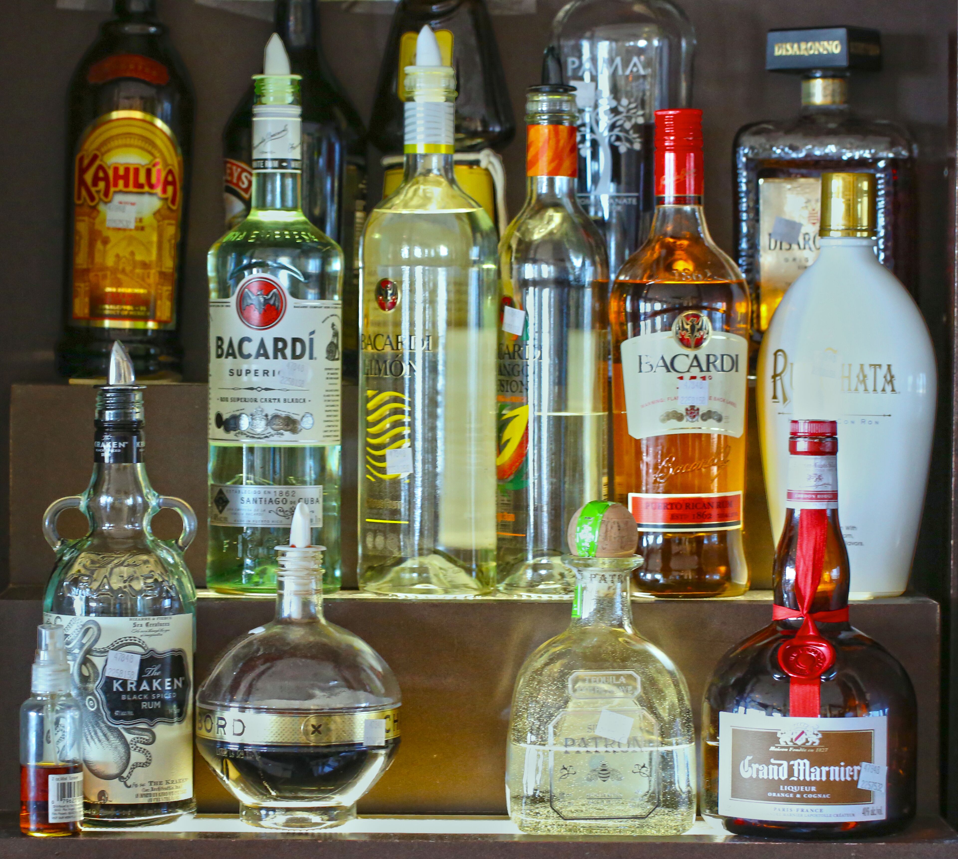 A variety of liquor bottles displayed on a shelf.
