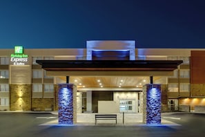 A Holiday Inn Express & Suites hotel entrance with a modern design, featuring a prominent entrance canopy and illuminated pillars. - Holiday Inn Express & Suites Wapakoneta by IHG (Wapakoneta)