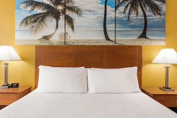 Hotel amenities such as safe, desk and work area at enVision Hotel Miami International Airport
