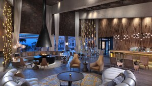 A modern lounge area with leather sofas, a central coffee table, and a bar with bottles. - Paradisus Los Cabos – Adults Only – All Inclusive – The Leading Hotels of the World (San José del Cabo)