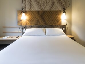 Premium bedding, desk, laptop workspace, blackout drapes