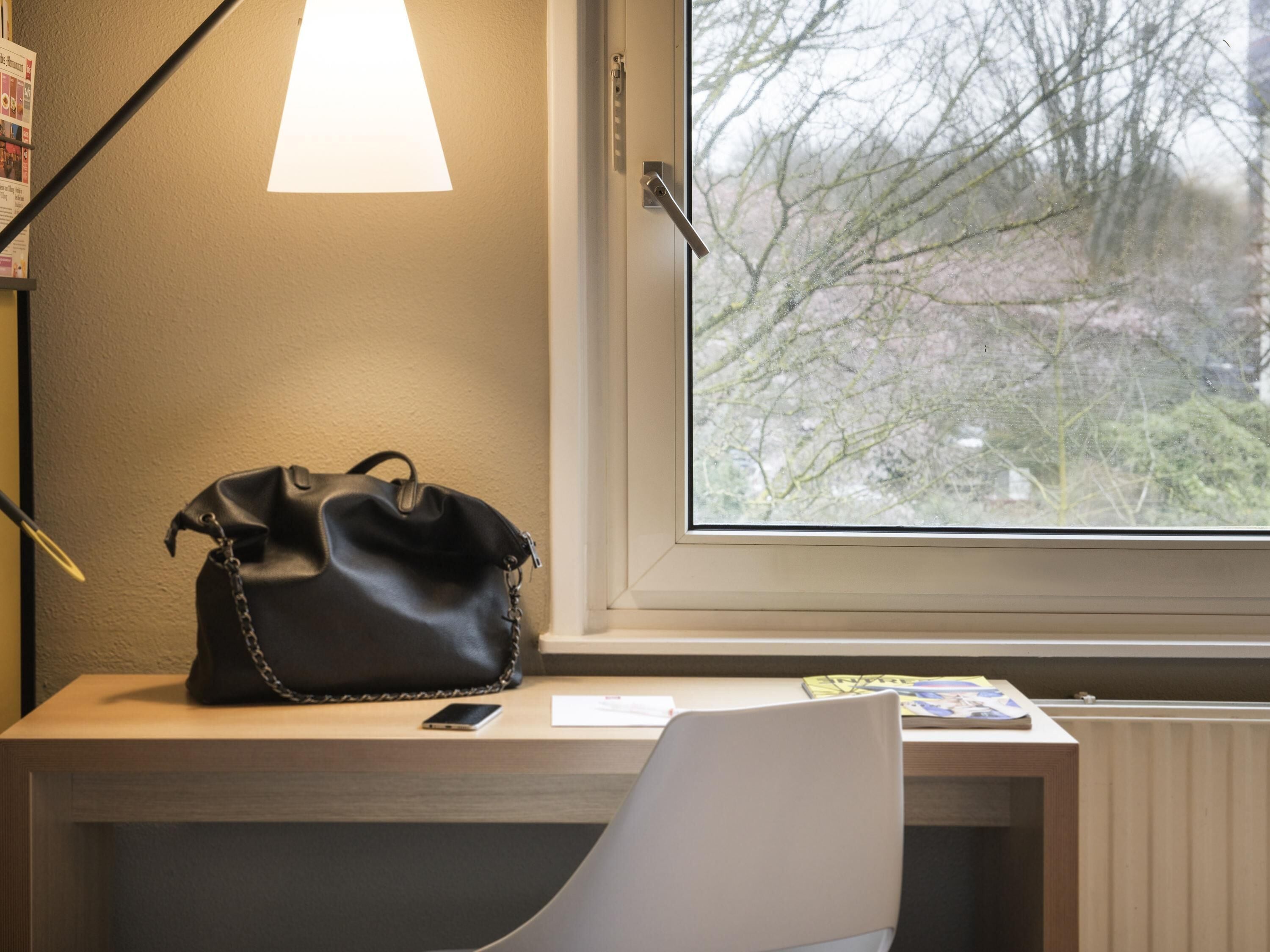 Premium bedding, desk, laptop workspace, blackout drapes