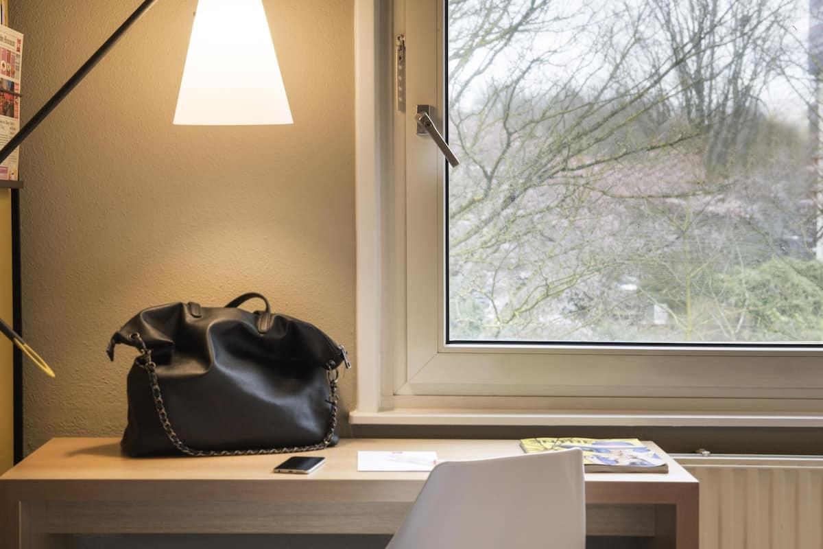 Premium bedding, desk, laptop workspace, blackout drapes