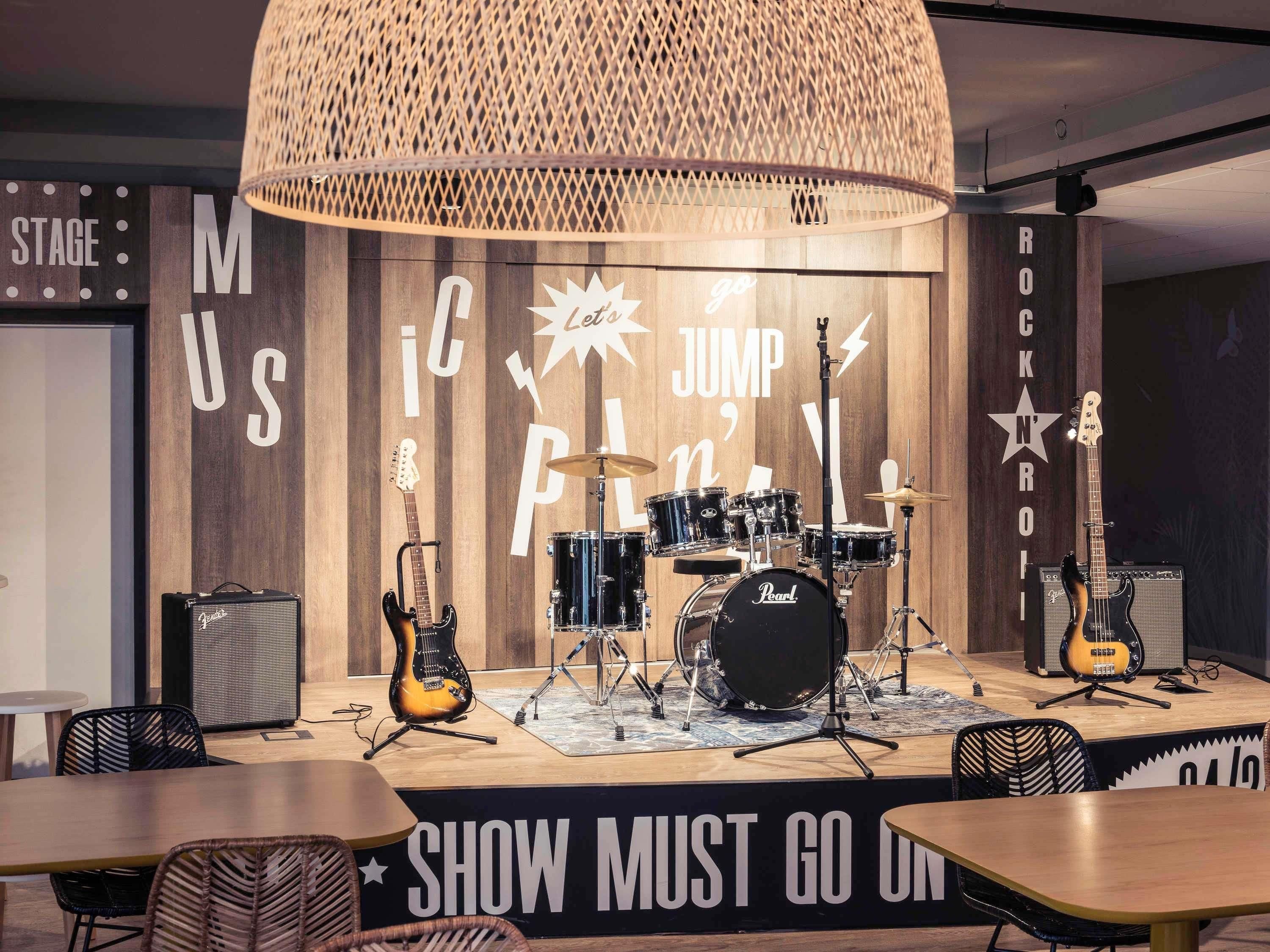 A stage with musical instruments and a sign that says 'SHOW MUST GO ON'.