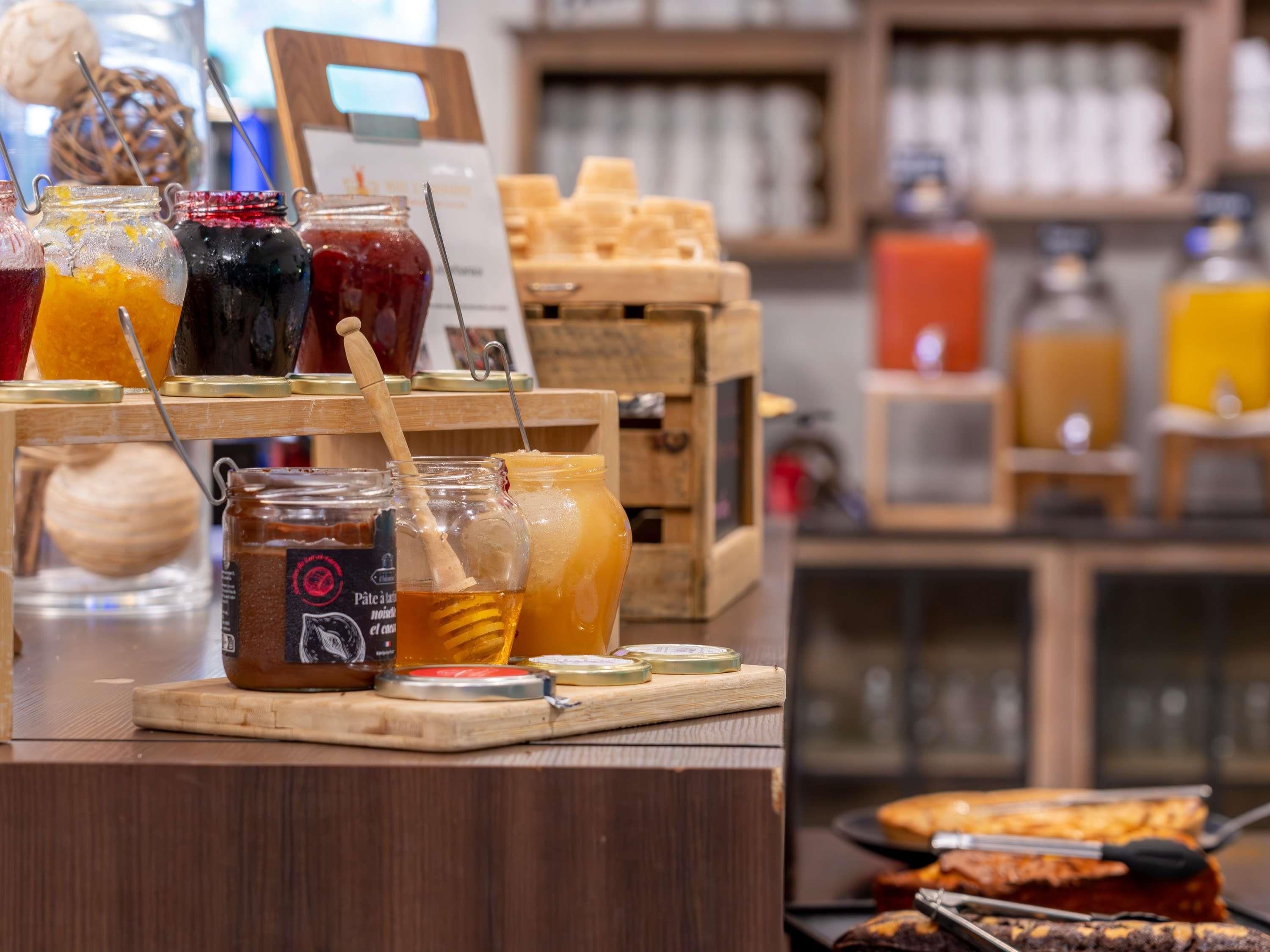 A breakfast buffet with various food items and condiments.