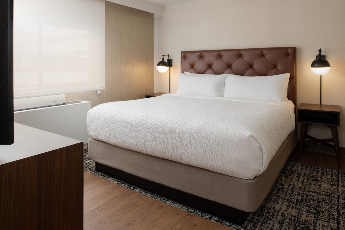 traditional suite, 1 king bed with sofa bed, non smoking, pool view | premium bedding, pillow-top beds, in-room safe, desk