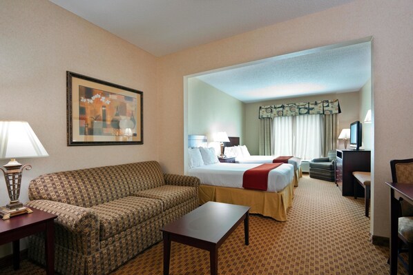 A hotel room with a sofa, a bed, a desk, and a television. - Holiday Inn Express Hotel & Suites Harriman by IHG (Harriman)