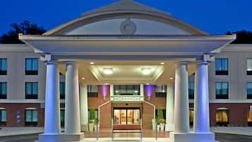 Stunning hotel entrance with a classical facade, featuring a central pediment and four columns.