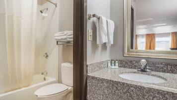 A bathroom with a shower, toilet, and sink.