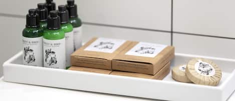 A tray with bottles of Forest & Bird essential skincare, boxes, and two wooden items.