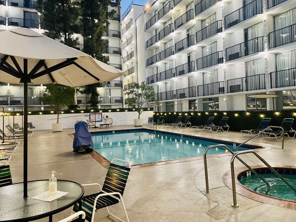 Outdoor pool, open 10:00 AM to 10:00 PM, pool umbrellas, pool loungers