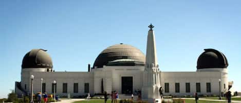 A large building with two domed structures and a tall central tower.