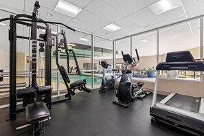A gym with a treadmill, elliptical, and weight machines. - Best Western Vista Inn At The Airport (Boise)