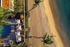 On the beach, white sand, sun-loungers, beach umbrellas