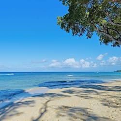 On the beach, white sand, sun loungers, beach umbrellas