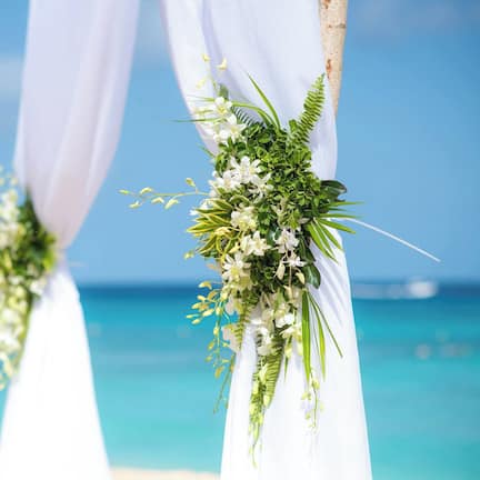 On the beach, white sand, sun loungers, beach umbrellas