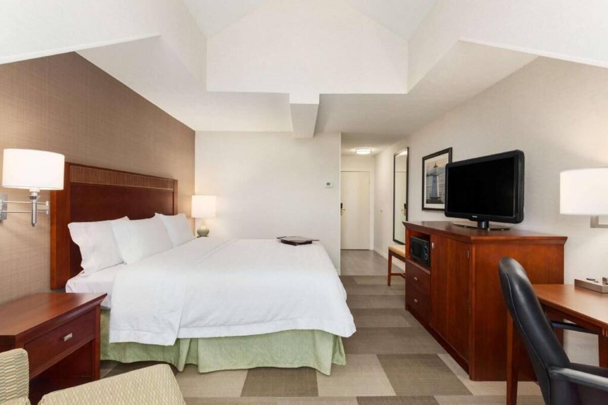 Hypo-allergenic bedding, desk, laptop workspace, blackout drapes