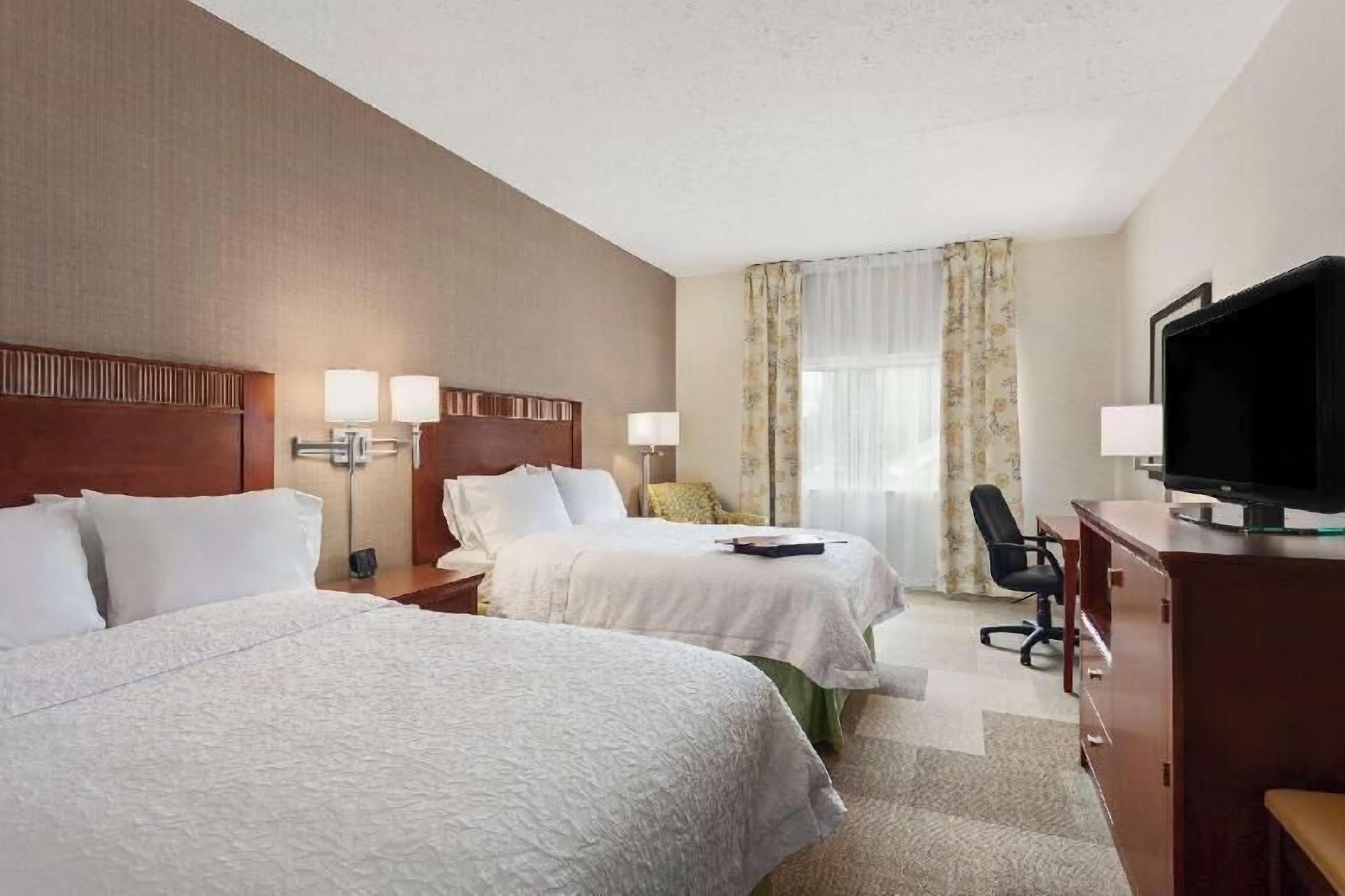 Hypo-allergenic bedding, desk, laptop workspace, blackout drapes