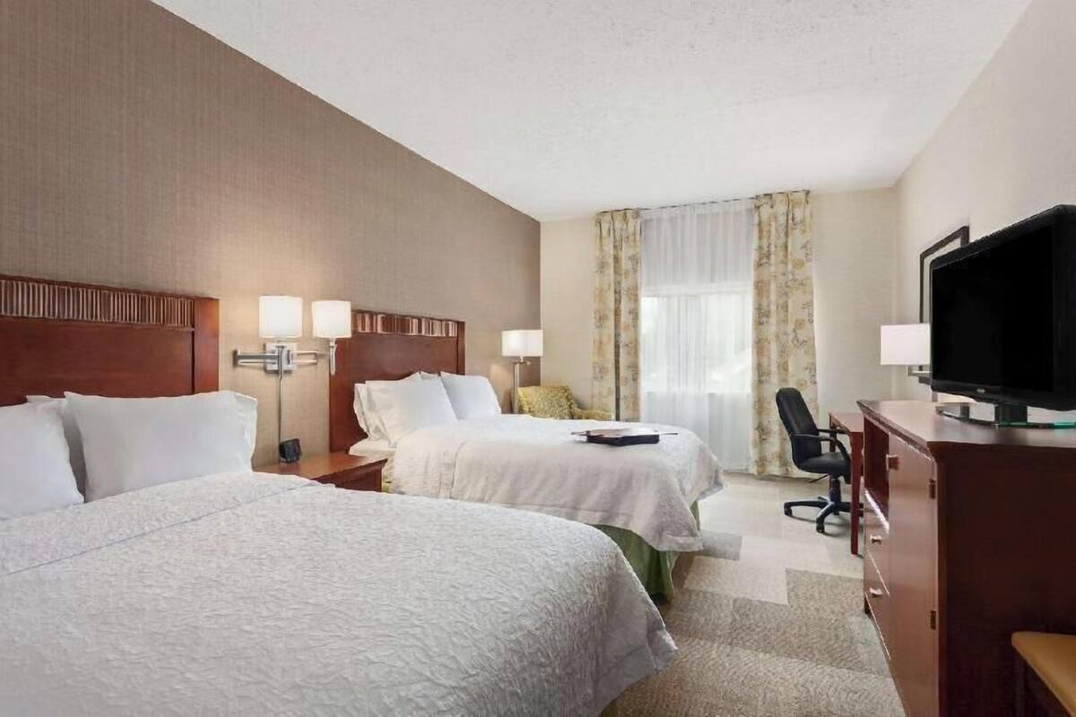 Hypo-allergenic bedding, desk, laptop workspace, blackout drapes