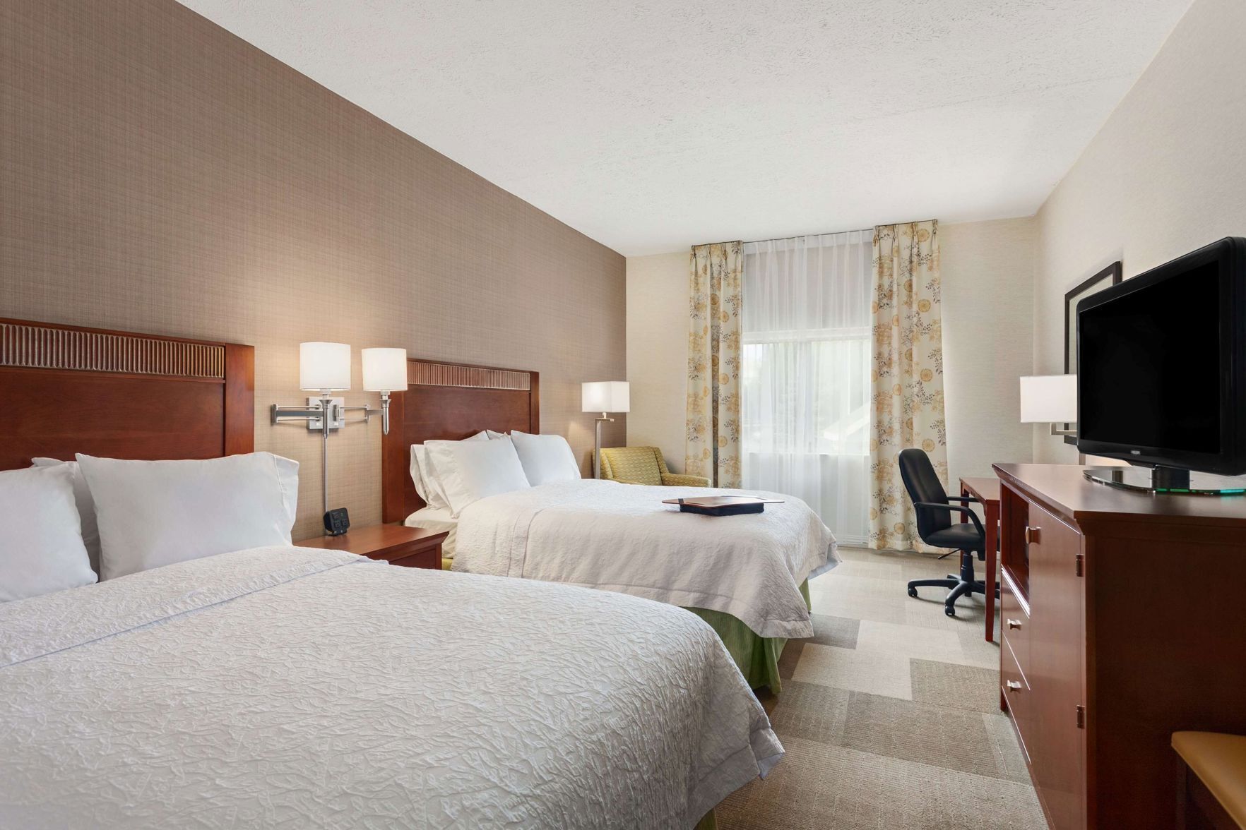 Hypo-allergenic bedding, desk, laptop workspace, blackout drapes