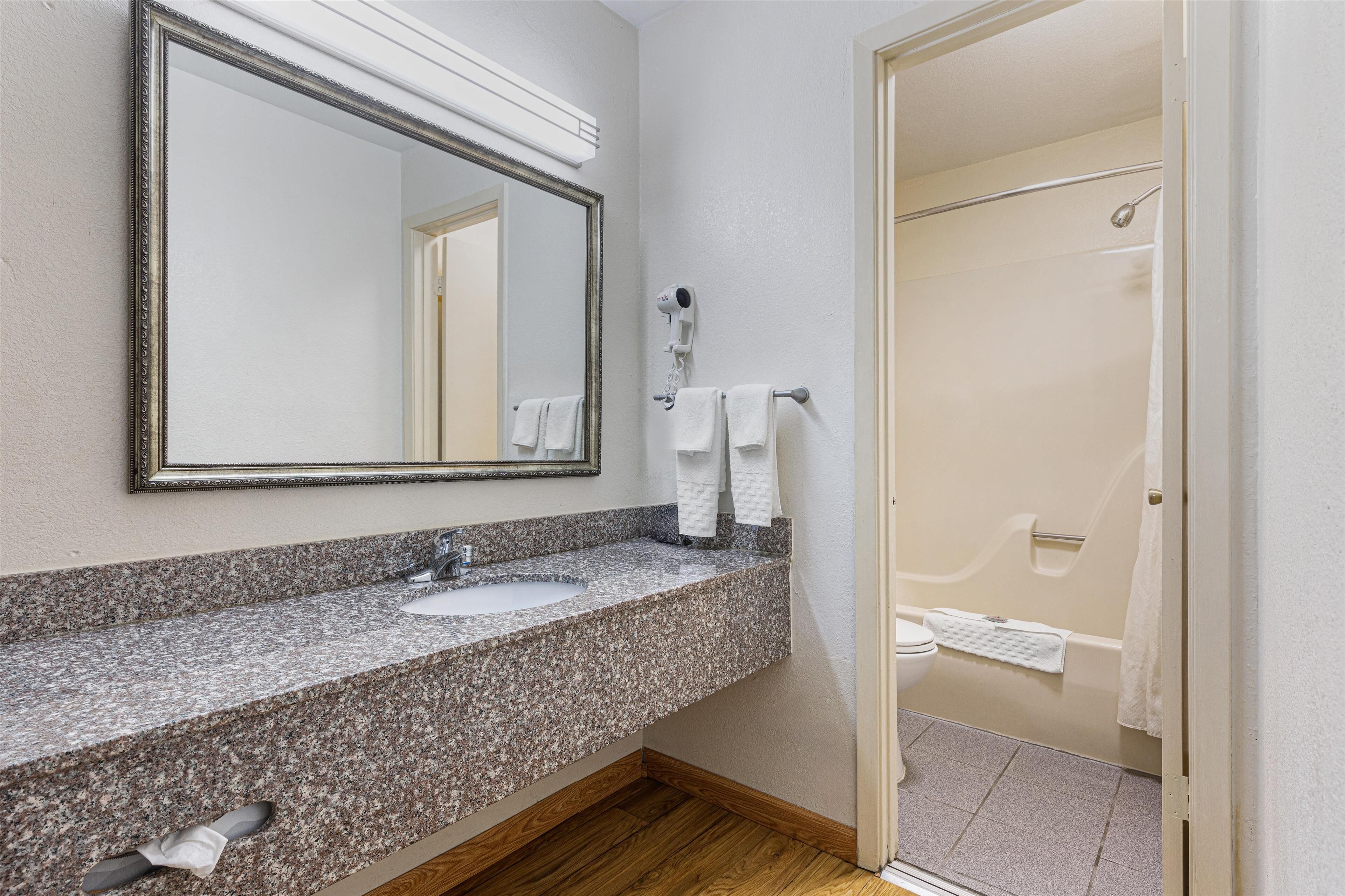 suite, 1 king bed, non smoking, refrigerator & microwave (with single sofabed;larger room) | bathroom | rainfall showerhead, free toiletries, hair dryer, towels