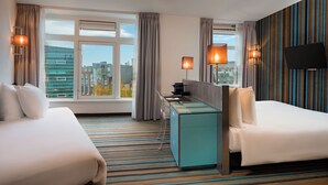 A hotel room with two beds, a desk, and a large window with curtains. - WestCord City Centre Hotel Amsterdam (Amsterdam)