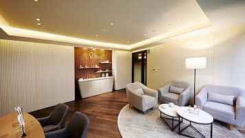 A modern lobby with a reception desk, seating area, and a spa sign.