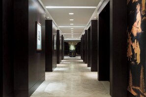 A corridor with dark walls, a patterned floor, and recessed lighting. - The Westin Josun Seoul (Seoul)