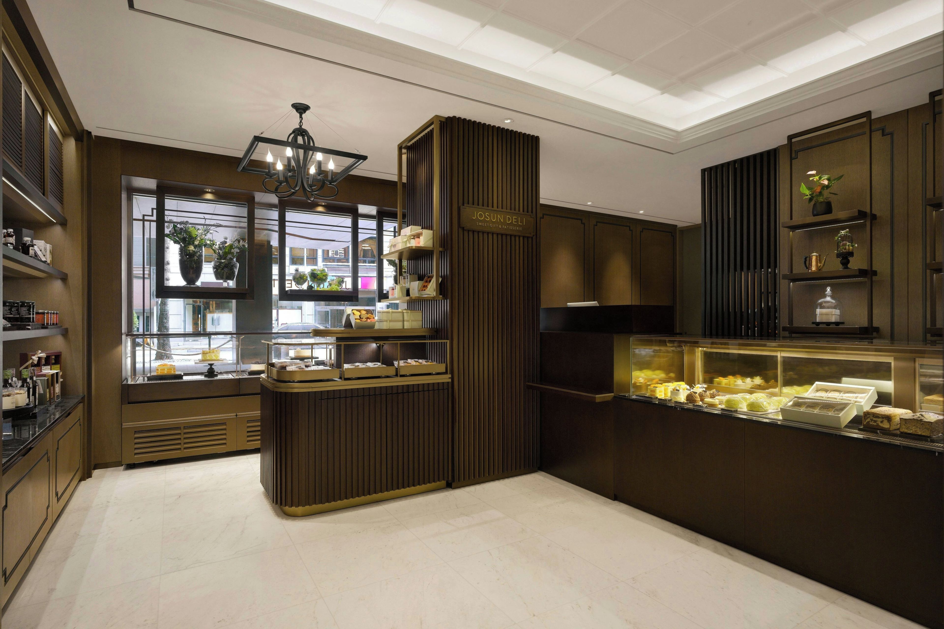 A bakery with a display case of pastries and a sign reading 'JOSUN Deli.'