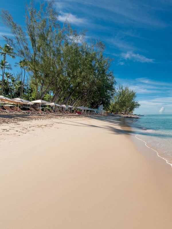 On the beach, white sand, sun loungers, beach umbrellas