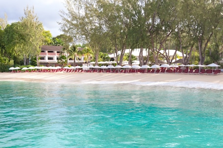 On the beach, white sand, sun loungers, beach umbrellas. Colony Club, a Luxury Collection Resort, Barbados