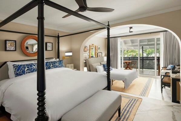 A spacious bedroom with a four-poster bed, a separate sitting area, and a balcony with a view. - Colony Club, a Luxury Collection Resort, Barbados (Holetown)