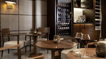A modern interior with wooden furniture, a wine rack, and a well-lit ambiance.