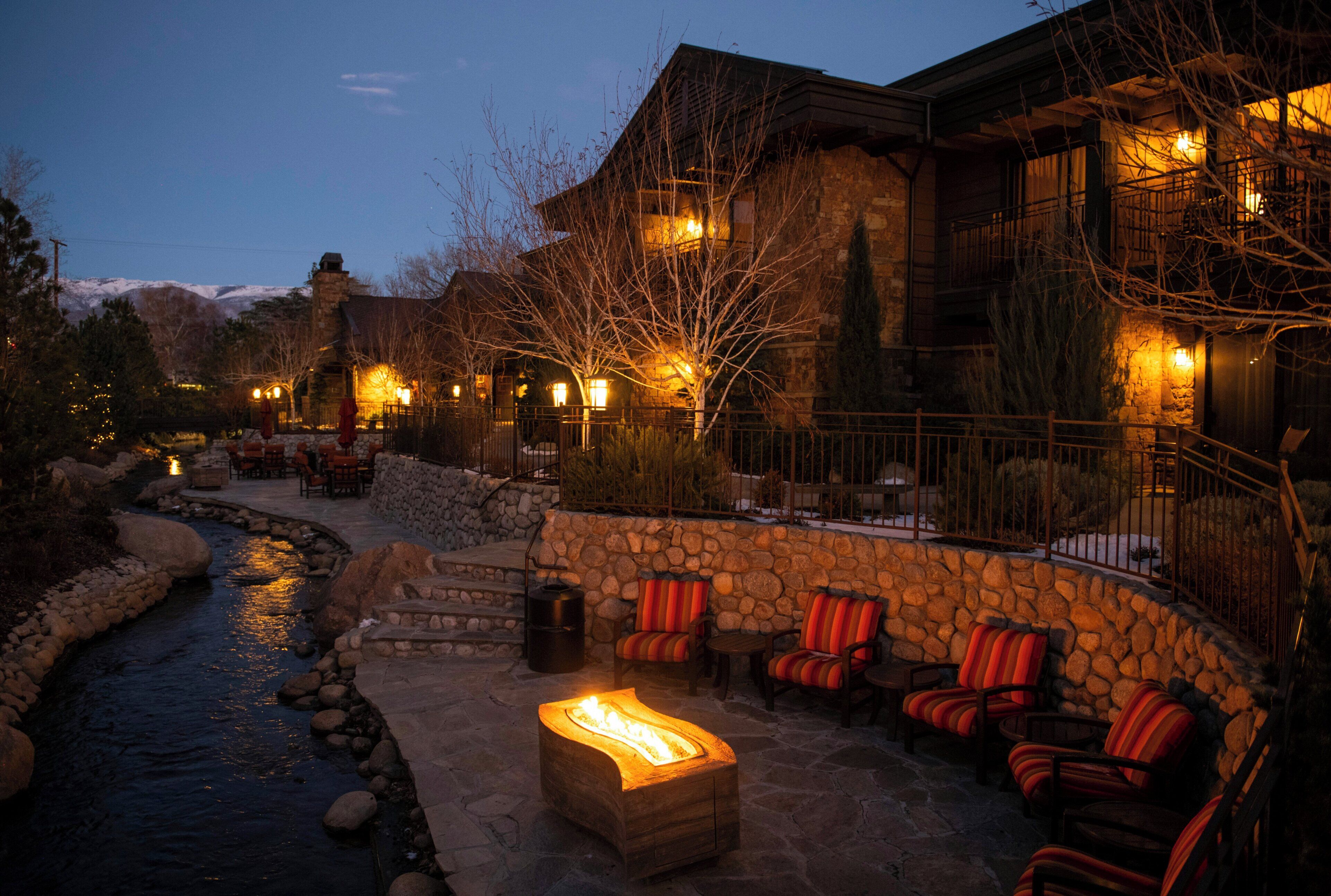 A stone building with outdoor seating and a fire pit.