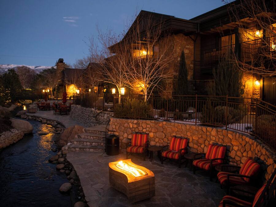 A stone building with outdoor seating and a fire pit.
