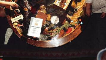 A wooden table with a menu and a sign for Creekside Club.