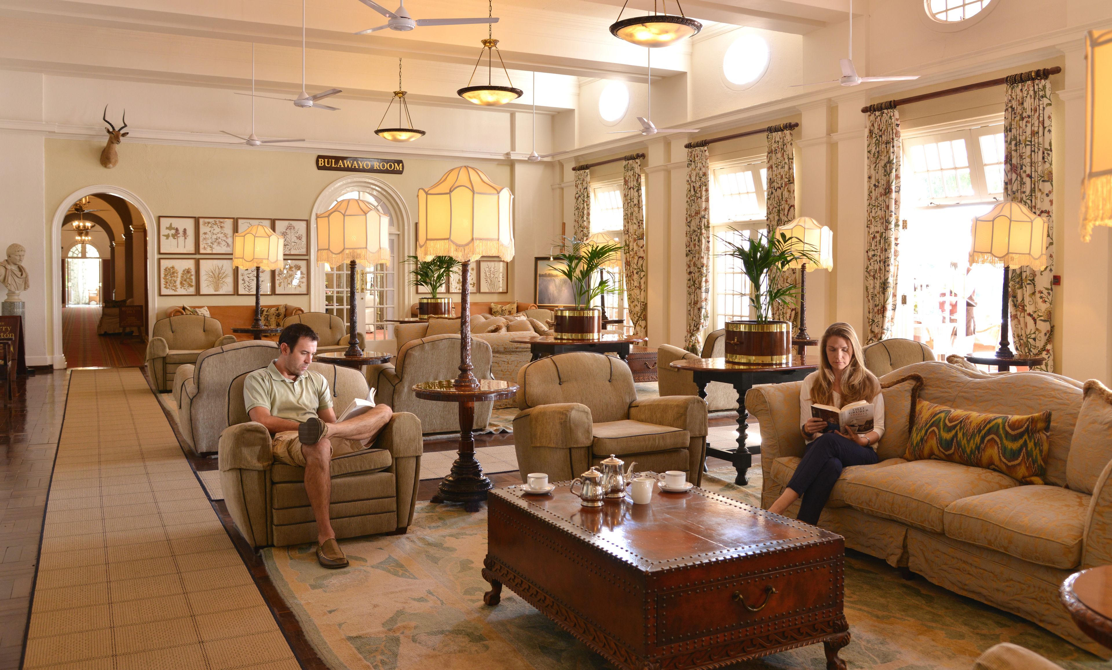 A spacious living room with multiple seating areas, a fireplace, and a dining table.