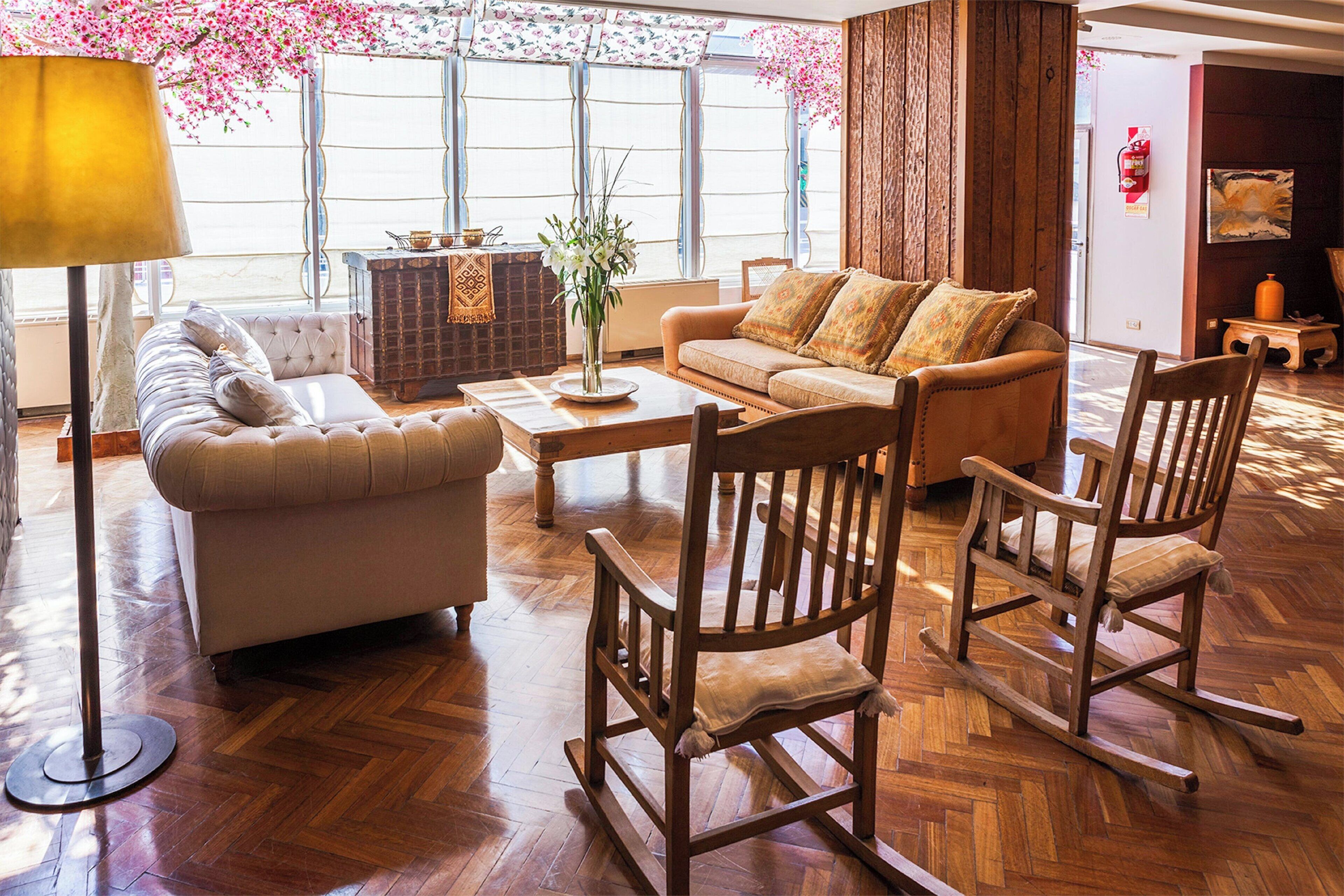 A spacious living room with a sofa, a coffee table, and a rocking chair.