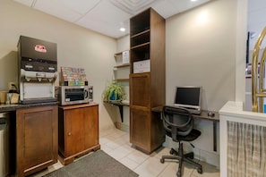A home office with a coffee machine, a computer desk, and a bookshelf. - Skyline Hotel Lake George (Lake George)