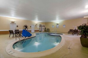 A hotel pool area with multiple pools, lounge chairs, and a covered seating area. - Skyline Hotel Lake George (Lake George)