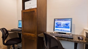 A workspace with two desktop computers, a printer, and office chairs. - Skyline Hotel Lake George (Lake George)