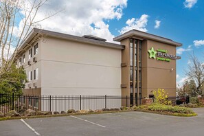 A hotel with a modern design, featuring a prominent sign for Extended Stay America Premier Suites.