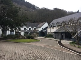 A residential area with multiple houses, paved pathways, and a grassy area.