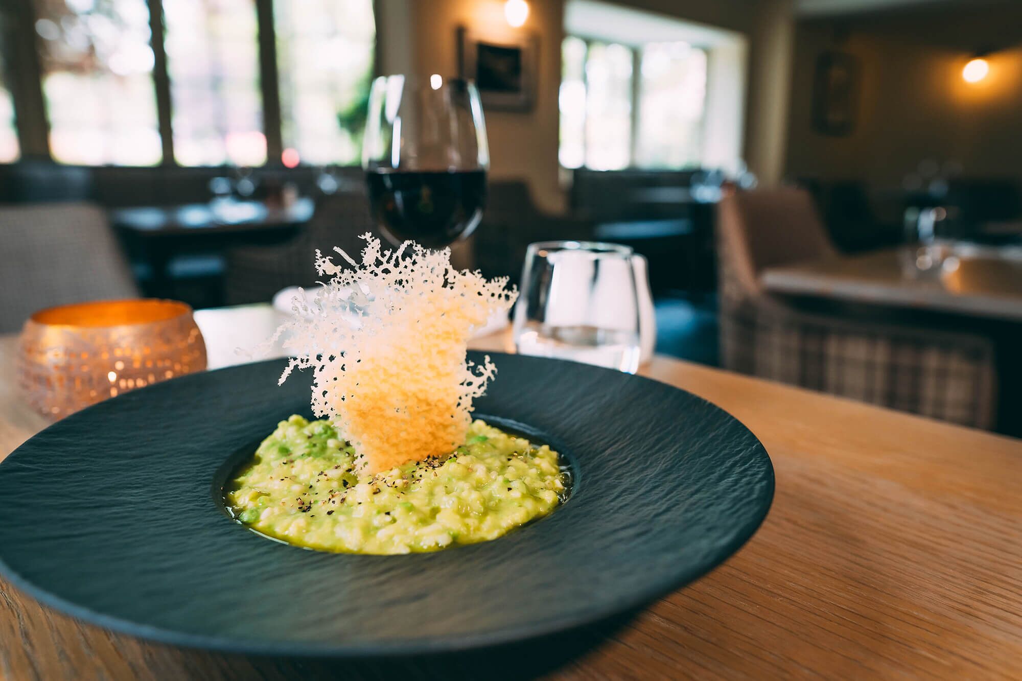 A plate of food with a decorative element on a table in a restaurant.
