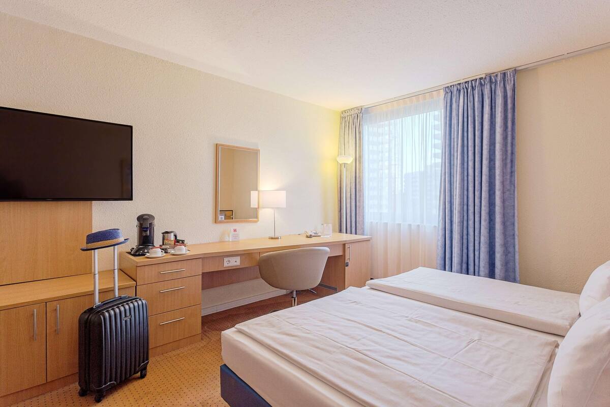 Hypo-allergenic bedding, desk, laptop workspace, blackout curtains